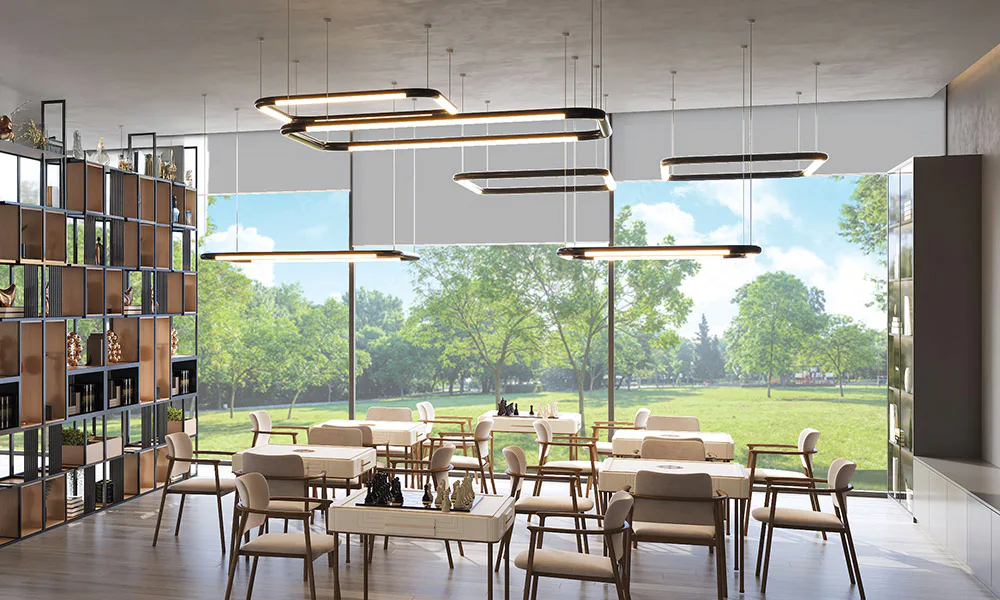 Indoor games lounge looking out over the landscaped green at Rustomjee Urban Woods
